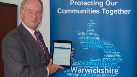 Warwickshire PCC Philip Seccombe with the Police and Crime Plan Consultation on an iPad.