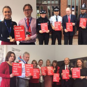 OPCC staff and police officers holding 'Show Racism the Red Car' banners