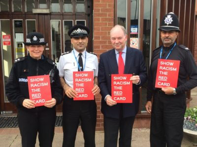 Warwickshire PCC Philip Seccombe with Police Officers holding Show Racism the Red Card placards
