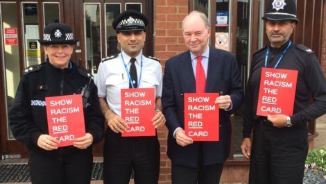 Warwickshire PCC Philip Seccombe with Police Officers holding Show Racism the Red Card placards