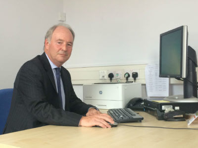Warwickshire Police and Crime Commissioner Philip Seccombe sitting at a computer