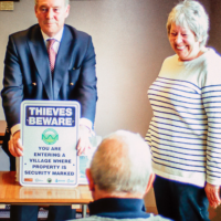 Philip showing off the new 'Thieves Beware' signs with Rachel Settle, Neighbourhood Watch co-ordinator for Willoughby.