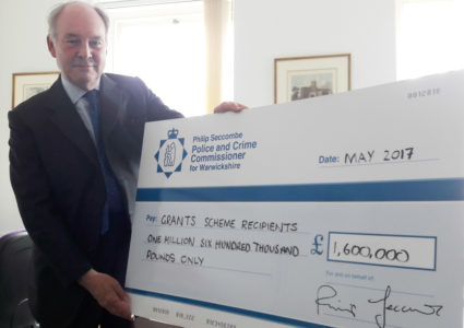 Warwickshire Police and Crime Commissioner Philip Seccombe with a cheque for good causes in Warwickshire