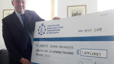 Warwickshire Police and Crime Commissioner Philip Seccombe with a cheque for good causes in Warwickshire