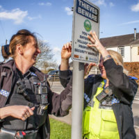 PC Paula Haden and PCSO Kamila Shilton from the Rugby Rural South SNT putting up the signs at the entrance to Willoughby