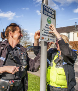 PC Paula Haden and PCSO Kamila Shilton from the Rugby Rural South SNT putting up the signs at the entrance to Willoughby