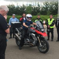 Riders watch on as the instructor talks through throttle control and correct gearing.