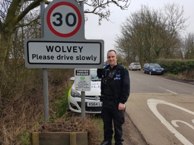 PC Stuart Baker from Warwickshire Police with the signage at the village entrance.