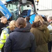 The PCC and officers examine agricultural machinery for vehicle identification markings.