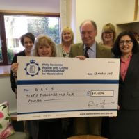 Presenting the cheque to staff at the Domestic Abuse Counselling Service in Bedworth.