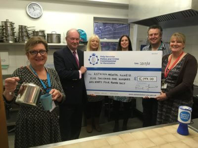 Warwickshire Police and Crime Commissioner Philip Seccombe presents a cheque for the funding to staff from Rethink Mental Illness during one of the drop-in coffee mornings at the centre in Warwick