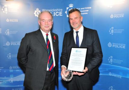 Warwickshire Police and Crime Commissioner handing the Award for Excellence in Policing and Community Safety to PC Martin Rone-Clarke.