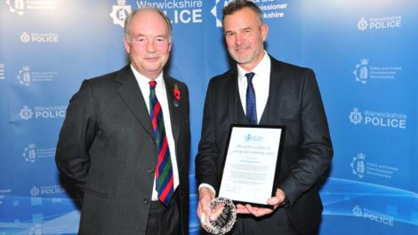 Warwickshire Police and Crime Commissioner handing the Award for Excellence in Policing and Community Safety to PC Martin Rone-Clarke.