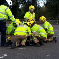 Fire and ambulance officers tend to a casualty during a mock road traffic collision demonstration.