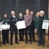 Chief Inspector Daf Goddard presenting the community box to Michael Koch, Chair of Marton Parish council with Carol Cotterill, Rural Crime Officer, PC Paula Haden, PCSO Kamilla Shilton from Rugby SNT and members of the Marton community.
