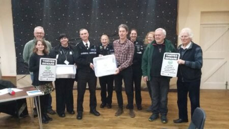 Chief Inspector Daf Goddard presenting the community box to Michael Koch, Chair of Marton Parish council with Carol Cotterill, Rural Crime Officer, PC Paula Haden, PCSO Kamilla Shilton from Rugby SNT and members of the Marton community.
