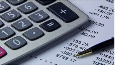 An image of a calculator and some financial documents
