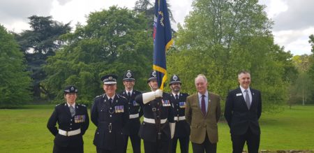 The PCC and uniformed police officers with the standard