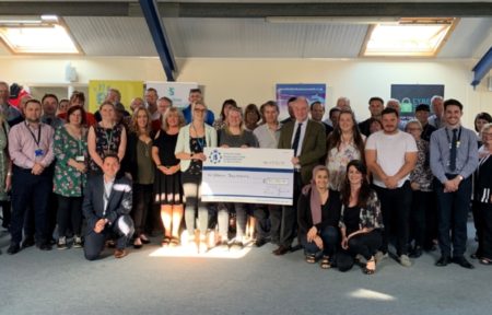 Grants recipients line up with PCC Philip Seccombe and a giant cheque