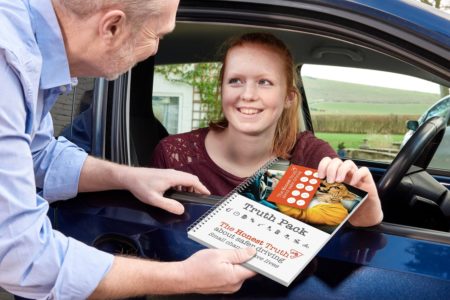 An ADI shows a learner driver the Honest Truth road safety pack