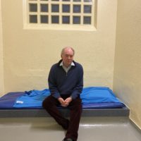 Philip Seccombe sitting in a cell at Leamington Police Station during his 'Night in Custody'