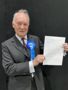 Philip Seccombe holding the signed Oath of Office