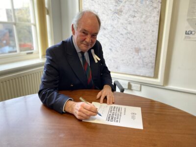Philip Seccombe signing the White Ribbon promise