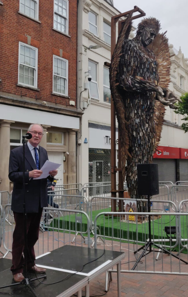 The Commissioner gives a speech in front of the statue.