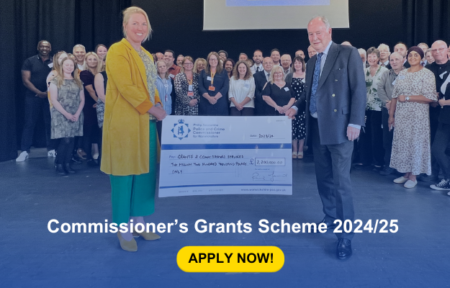 Two people holing a giant cheque in front of a group of people. Caption says Commissioner’s Grants Scheme 2024/25 Apply now!