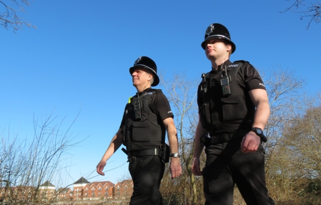 Two police officers walking in uniform